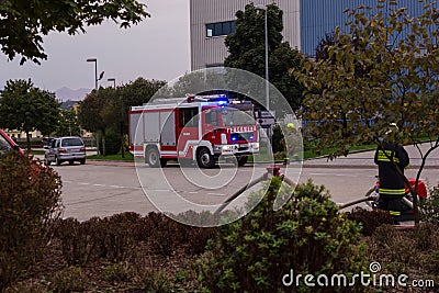 LAAKIRCHEN, AUSTRIA SEPTEMBER 24, 2015: Firefighters and fire tr Editorial Stock Photo