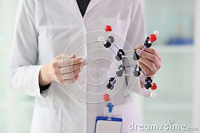 Lab assistant demonstrates molecule model close view Stock Photo