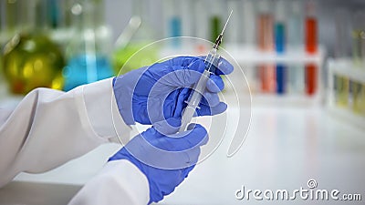 Lab assistant filling syringe with vaccine, antihistamine medication injection Stock Photo