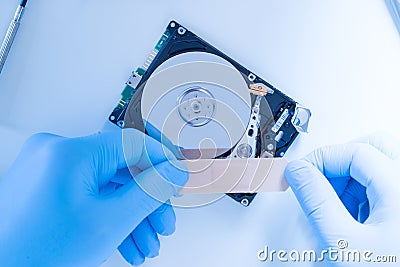 Lab engineer working on broken hard disk Stock Photo