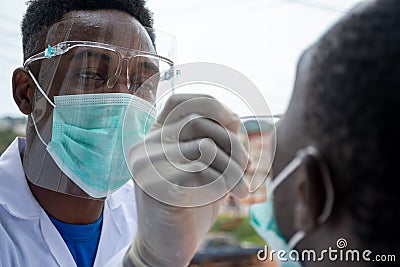 Lab scientist taking nasal sample from a man Stock Photo