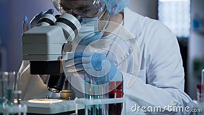 Lab technician conducting researches based on blood samples, quality medicine Stock Photo