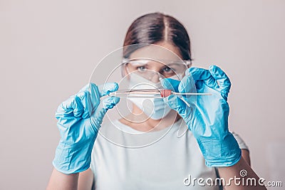 Lab technician holding kit test for PCR testing virus covid19. Coronavirus COVID-19 swab test kit, PPE protective mask and gloves Stock Photo