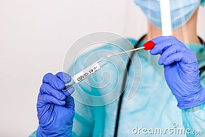 Lab technician holding swab collection kit,Coronavirus COVID-19 specimen collecting equipment,DNA nasal and oral swabbing for PCR Stock Photo