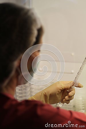 Lab technician measuring a liquid in a laboratory. Stock Photo