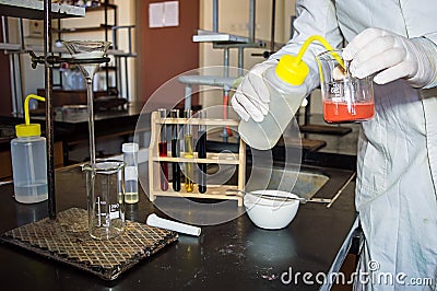 Lab Technician's Hands in Gloves Dilution Red Liquid Stock Photo
