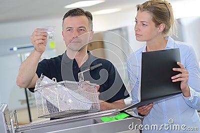 Lab technician with urine specimen on table Stock Photo