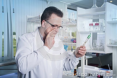 Lab worker observing test tube with mold at the laboratory Stock Photo