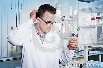 Lab worker in observing test tube with mold at the laboratory Stock Photo