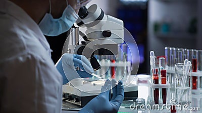 Lab worker preparing glass with blood for detection of antibodies and infections Stock Photo