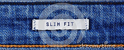 Close-up of a textile label with the inscription `Slim Fit` in banner format Stock Photo