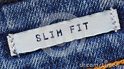 Close-up of a textile label with the inscription `Slim Fit` Stock Photo