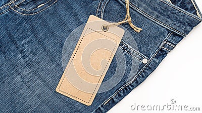 Label price tag mockup on blue jeans from recycled paper. Stock Photo