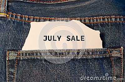 Label with text july sale in the pocket of blue denim jeans. Stock Photo