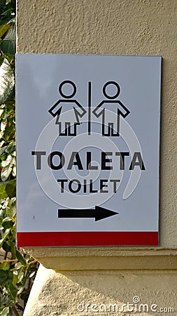 Label on the wall showing direction to the toilet written both in Czech and English Editorial Stock Photo
