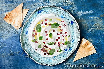 Labneh middle eastern lebanese cream cheese dip with pomegranate, molasses and mint. Top view Stock Photo