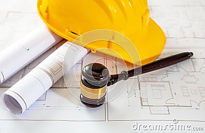 Labor, Construction law. Safety helmet and judge gavel on building blueprint Stock Photo