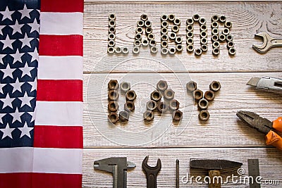 Labor day. American flag and Inscription labor day and various tools on a light wooden background Stock Photo