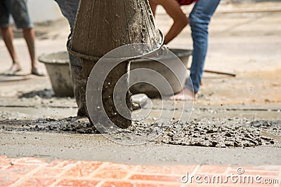 labor pouring cement on the ground for build new floor for renovation house Stock Photo