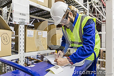 Labor wearing uniform and hard hat writing Stock Photo