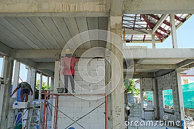 labor working in new house structure use lightweight cement brick and white lintel plaster to joint for reinforce in site.steel Editorial Stock Photo