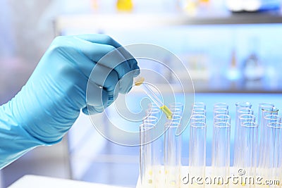 Laboratory assistant dripping urine sample for analysis from pipette into test tube Stock Photo