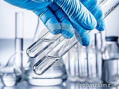 Laboratory beakers in analyst`s hand. Stock Photo