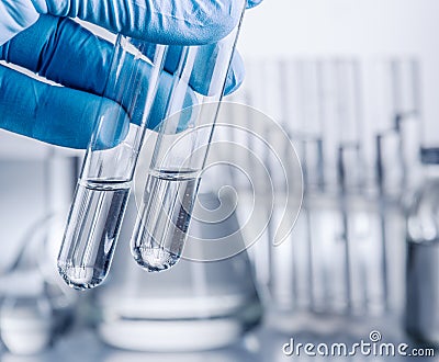 Laboratory beakers in analyst`s hand. Stock Photo