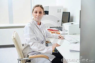 Laboratory employee is sitting at her desk Stock Photo