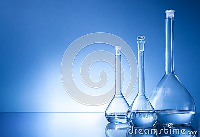 Laboratory equipment, three glass flask on blue background Stock Photo