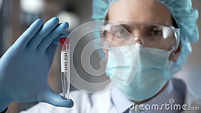 Laboratory expert holding blood test for HIV antibodies, infection prevention Stock Photo