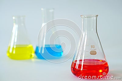 Laboratory glass Erlenmeyer conical flask filled with chemical liquid. Stock Photo