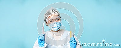 Laboratory and medical tests concept. Smiling asian female doctor, lab worker showing tubes with clinical testing Stock Photo