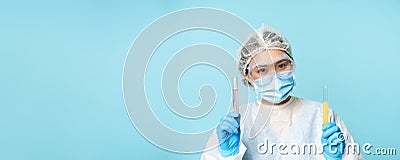 Laboratory and medical tests concept. Smiling asian female doctor, lab worker showing tubes with clinical testing Stock Photo