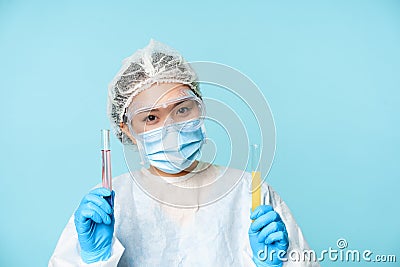 Laboratory and medical tests concept. Smiling asian female doctor, lab worker showing tubes with clinical testing Stock Photo