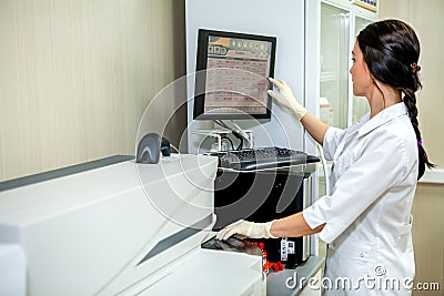 Laboratory Specialist Introduces Settings for Blood Testing Apparatus Editorial Stock Photo