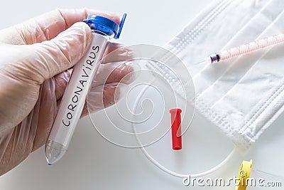 Aboratory vials with hand-written `coronavirus` concept, epidemiological threat of virus. Notebook with the virus designation wri Stock Photo