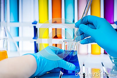 Laboratory worker analyzes chemical liquid in a flask. Stock Photo