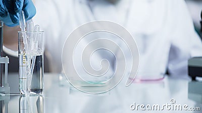 Laboratory worker checking viscosity and kinetic abilities of substance, science Stock Photo