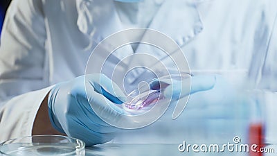 Laboratory worker conducting research testing consistency of biological material Stock Photo