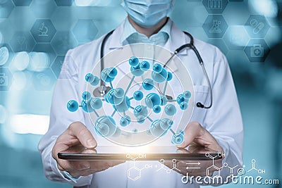 Laboratory worker shows molecules on a tablet Stock Photo