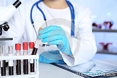 Laboratory worker taking test tube with blood sample Stock Photo