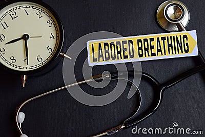 Labored Breathing on the paper with Healthcare Concept Inspiration. alarm clock, Black stethoscope. Stock Photo
