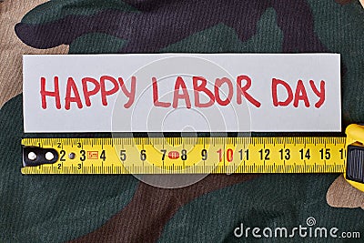 Labour Day card on camouflage. Stock Photo