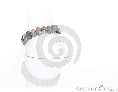 Labradorite bracelet on a white display stand. Collection of natural gemstones accessories. Studio shot Stock Photo