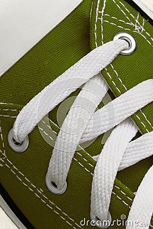 Lacing on a retro sneaker, close-up, on a blue wooden background Stock Photo