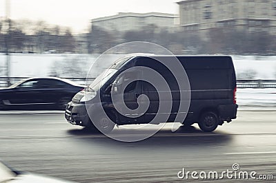 Lack Peugeot Boxer van vehicle on city road. Fast moving car on winter street Editorial Stock Photo