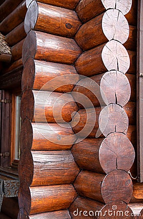 Lackered Warm corner of a log wooden blockhouse, close-up. Wooden house construction, architecture Stock Photo