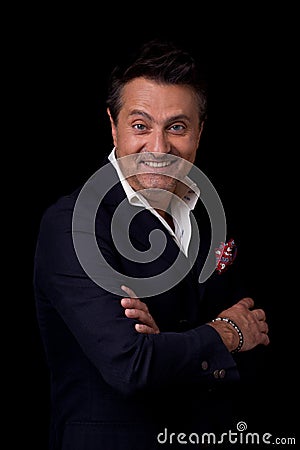 Expressive Frenchman smiling happily while looking at you Stock Photo