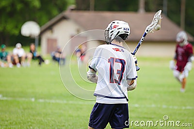 Lacrosse player in the green field in action Editorial Stock Photo